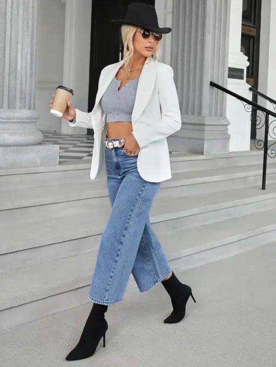 white blazer with a gray crop top, wide-leg pants, and black boots